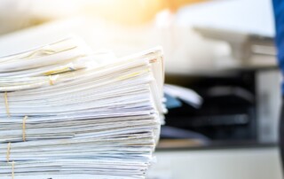 Stacks of paper close up signifying document management