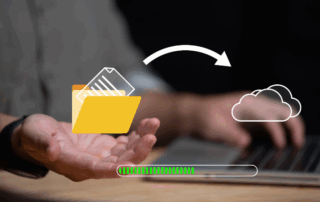 File folder and cloud icons with an arrow going from the file to the cloud in front of a close up of a person on a laptop conceptualizing file conversion services