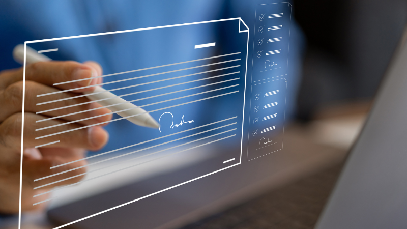 Close up of a person signing an icon image of a document symbolizing digital forms.