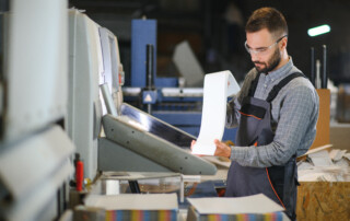 KDI production team reviewing large format print job for fast turnaround business printing support