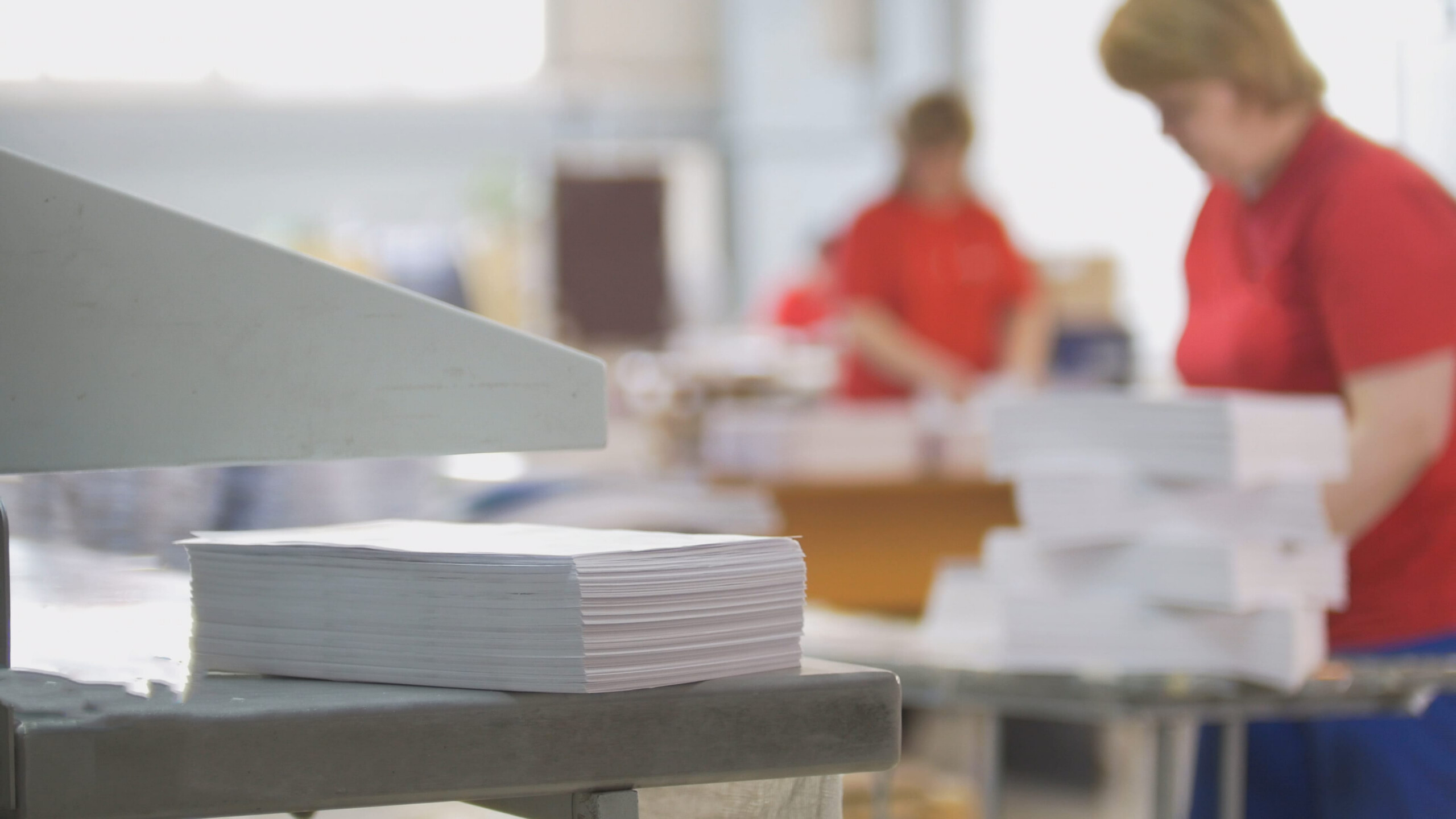 High volume commercial printing with stacks of printed documents in production