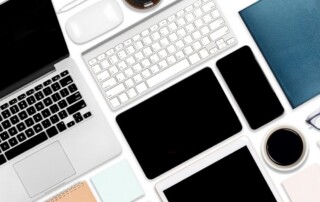 Multiple business devices including laptop, tablet, and phone used in office technology