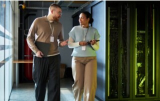 Two business professionals walking through a server room discussing IT infrastructure, backup, and recovery systems