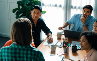 Business team reviewing office technology requirements and workflow improvements during a managed print services consultation