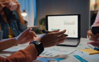 Employees reviewing business processes and productivity data to identify workflow bottlenecks