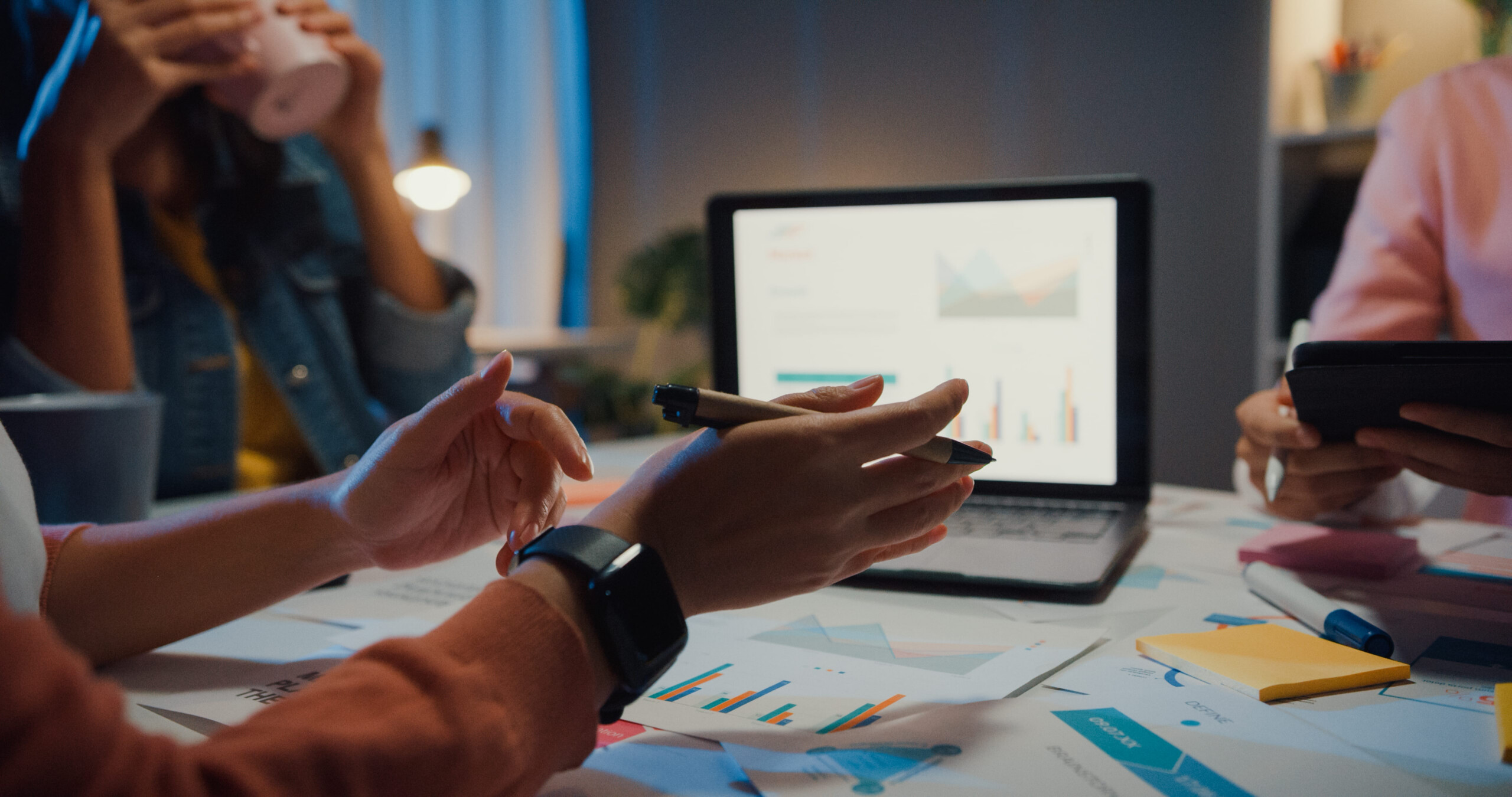 Employees reviewing business processes and productivity data to identify workflow bottlenecks