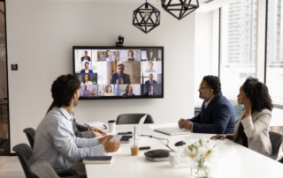 Business professionals collaborating with modern communication technology during a team meeting.