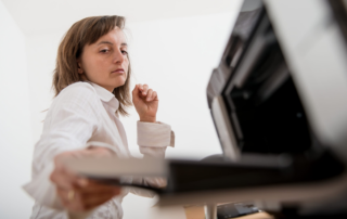 Business professional dealing with an office printer problem
